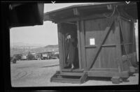 Mertie West exits a restroom at Lake Mead, Boulder City vicinity, 1939