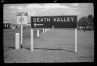 Road signs for Junction 127 and Death Valley, viewed from off the side of a road, Baker, 1939
