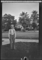 Boy stands on the lawn of the West's house at 2223 Griffin Avenue, Los Angeles, about 1932