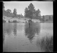 Man fishes in Jackson Lake, Big Pines vicinity, 1933