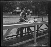 Harry Lawrence and Otto Pease wash their clothes at Big Pines Scout Camp, Big Pines vicinity, 1933
