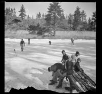 Visitors to Jackson Lake put on ice skates and skate on the frozen lake, Big Pines vicinity, 1934