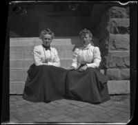 Nella Brydolf and a fellow teacher sit on the stairs in front of the school where they taught, Burlington, 1900