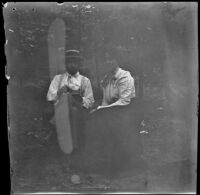 Man and woman sitting in a wooded area, Burlington, 1900