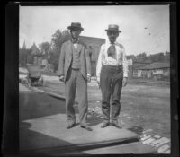 Fred Lemberger and a friend pose on a sidewalk, Burlington, 1900