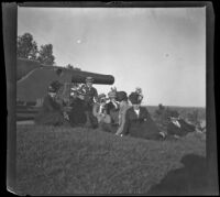 Members of the West, Biddick, Brydolf and Parsons families sit near a cannon in Crapo Park, Burlington, 1900