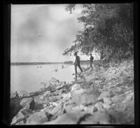 Two men fish for eels on an island in the Mississippi River, Burlington, 1900