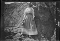 Woman stands on the rocks, Santa Catalina Island, 1903