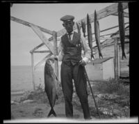 George Thomas of Pomona poses for a photograph with a fish he caught, Santa Catalina Island, 1909