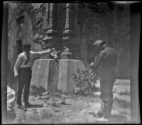 Floyd Purdy takes a photograph of someone catching an owl at the ruins at the Mission, San Juan Capistrano, about 1912