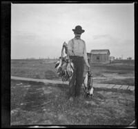 Guy Mansberger poses with ducks killed on a shoot, Orange County vicinity, about 1912