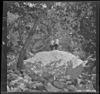 Frances West and Elizabeth West stand on a large rock in Chatsworth Park, Los Angeles, circa 1915
