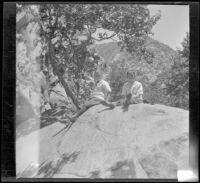 Frances West and Elizabeth West sit on a large rock in Chatsworth Park, Los Angeles, circa 1915