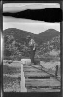 Glen Velzy walks on a wooden walkway in Chatsworth Park, Los Angeles, about 1910