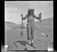 Elizabeth West poses with fish caught in Convict Creek, Mammoth Lakes vicinity, 1914