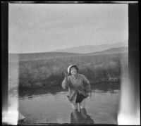 Bessie Velzy wades into Whitmore Tub, Mammoth Lakes vicinity, 1914