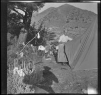 Minnie West stands by a tent at camp near Convict Lake, Mammoth Lakes vicinity, 1915