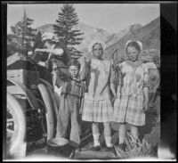 Elizabeth West, Frances West and Ted McClellan's son pose with fish, Mammoth Lakes vicinity, 1915