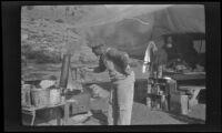 Edward Steinberg cooks fish near Convict Lake, Mammoth Lakes vicinity, 1918
