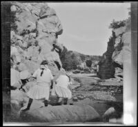 Elizabeth West and Frances West wade in Crooked Creek, Mono County, about 1915