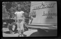 Betty Barbara Gordon standing next to her father's truck, Lake Arrowhead vicinity, 1938