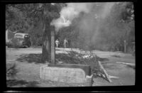 Cook stove producing smoke at the Siemsen camp, Lake Arrowhead vicinity, 1938