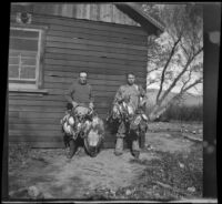 H. H. West and Roger Stearns pose with ducks and a goose, Gorman vicinity, circa 1910s