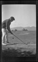Jesse F. Brown gets ready to drive a golf ball, Monterey vicinity, about 1920