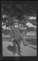 F. M. "Kid" Murray stands with his golf clubs, Monterey vicinity, about 1920
