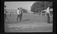 Jim Scullin and others stand around the teeing ground of a golf hole, Monterey vicinity, about 1920