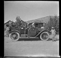 Elizabeth West poses next to the car near Dove Springs, Kern County, about 1915