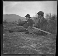 George M. West and Frank Lemberger sit in the grass during a rabbit shoot, Duarte, about 1897