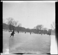 People ice skate on the frozen pond at the Public Garden, Boston, 1914