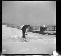 A man shovels snow from a sidewalk, Niagara Falls (Ontario), 1914