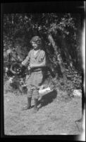 Mertie West handles a fishing rod, Redlands vicinity, about 1927