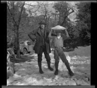 H. H. West and H. H. West, Jr. pose in the snow, Redlands vicinity, about 1930