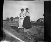Mertie Whitaker and Lelia Gillan sit on a brick structure, Fresno, 1901