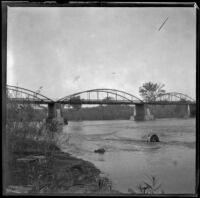 A truss bridge spans a river, Germanville, 1900