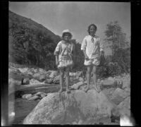 Frances Cline and Elizabeth West pose atop a boulder, Sunland-Tujunga vicinity, [about 1910-1915]