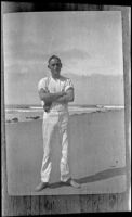 Wilfrid Cline poses by the Pacific Ocean at Abalone Point, Laguna Beach vicinity, about 1917