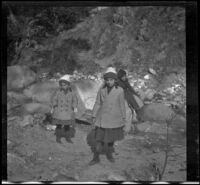 Frances West and Elizabeth West stand near a creek, Mount Wilson vicinity, about 1911