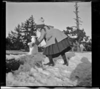 Elizabeth West builds a tiny snowman, Mount Wilson vicinity, about 1911