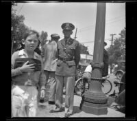 Major Berg of the R. O. T. C. stands by a streetlamp wearing his uniform, Glendale, 1937