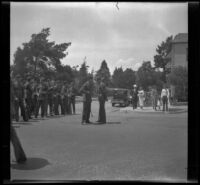 H. H. West talks to the Captain of an R. O. T. C. company while cadets and others stand by, Glendale, 1936