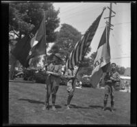 Three Boy Scouts hold flags in preparation for the Decoration Day Parade, Glendale, 1937