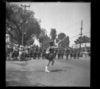 Molly Johnston performs during the Decoration Day Parade as spectators watch and troops line the street, Glendale, 1937