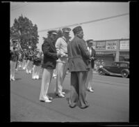 Arnold Burgener stands with other men while a marching band lines up behind them for the Decoration Day Parade, Glendale, 1937