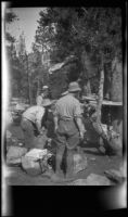 Glen Velzy and Charlie Stavnow breaking up camp on the trip to Gardner Creek, about 1919