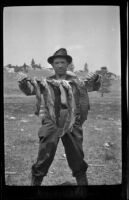 H. H. West poses with 5 trout, June Lake, about 1920