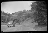 H. H. West's car approaching a rock tunnel in Red Canyon, 1942
